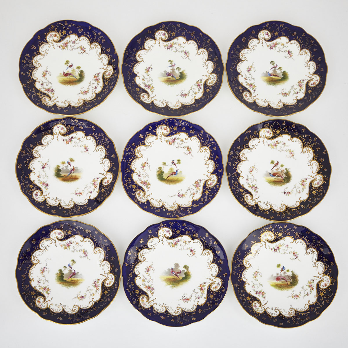 Nine Coalport Blue Ground Dessert Plates, early 20th century
