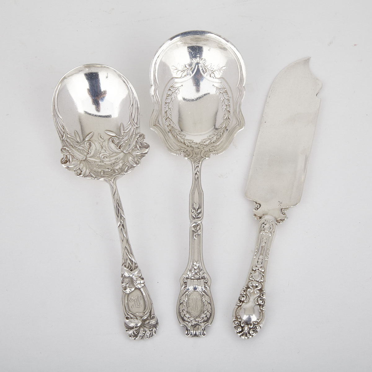 Two American Silver Berry Spoons, Wm. B. Durgin Co., Concord, N.H. and a Canadian Serving Knife, Roden Bros., Toronto, Ont., early 20th century