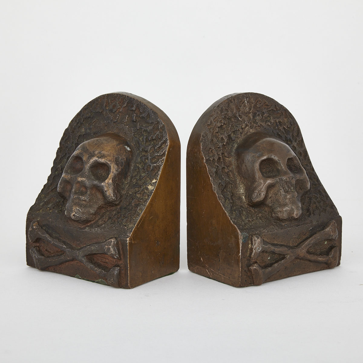 Pair of Cast Solid Bronze ‘Skull and Crossbones’ Bookends, early 20th century