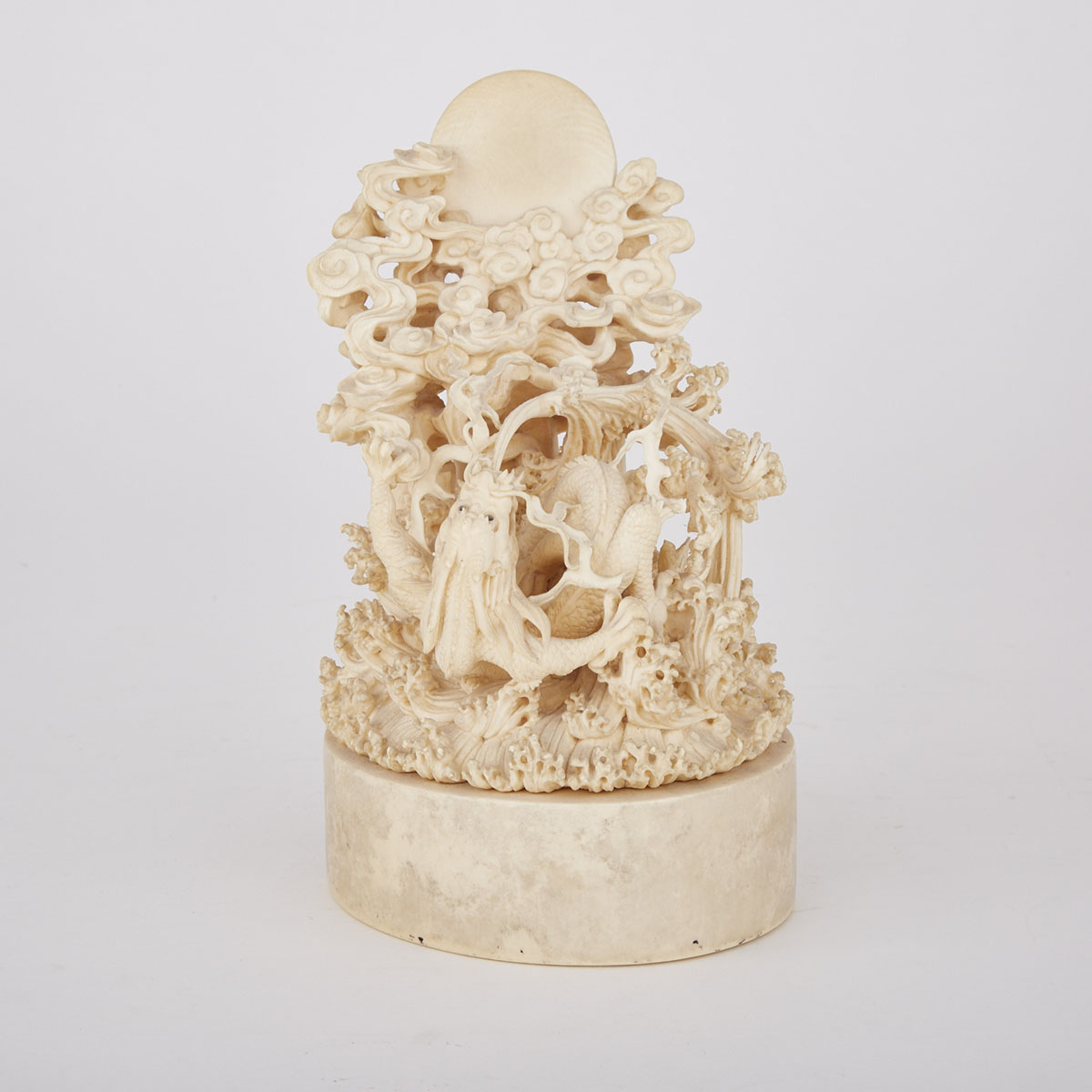 A Finely Carved Ivory Dragon Amongst Waves, Early 20th Century