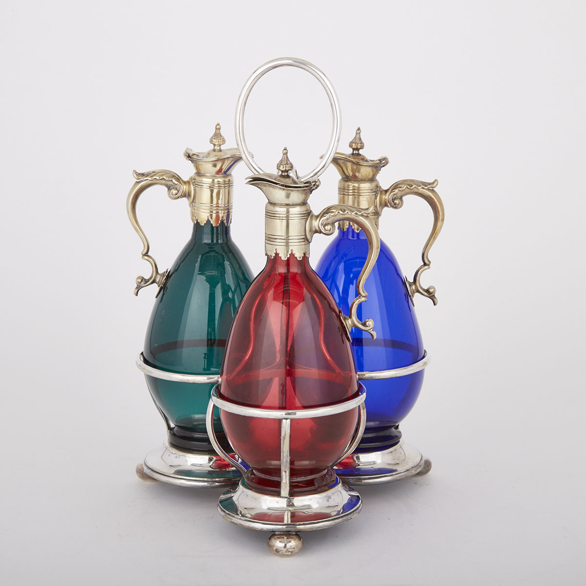 Edwardian Silver Plated and Coloured Glass Three-Bottle Tantalus, early 20th century