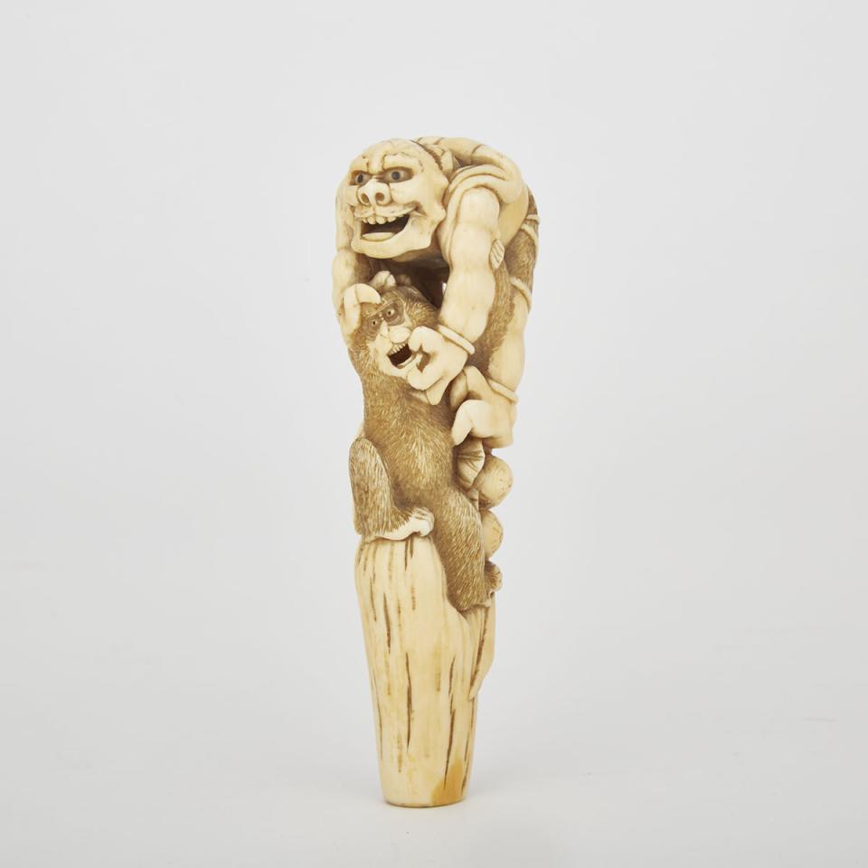 A Carved Ivory Oni and Monkey Cane Handle, Meiji Period 