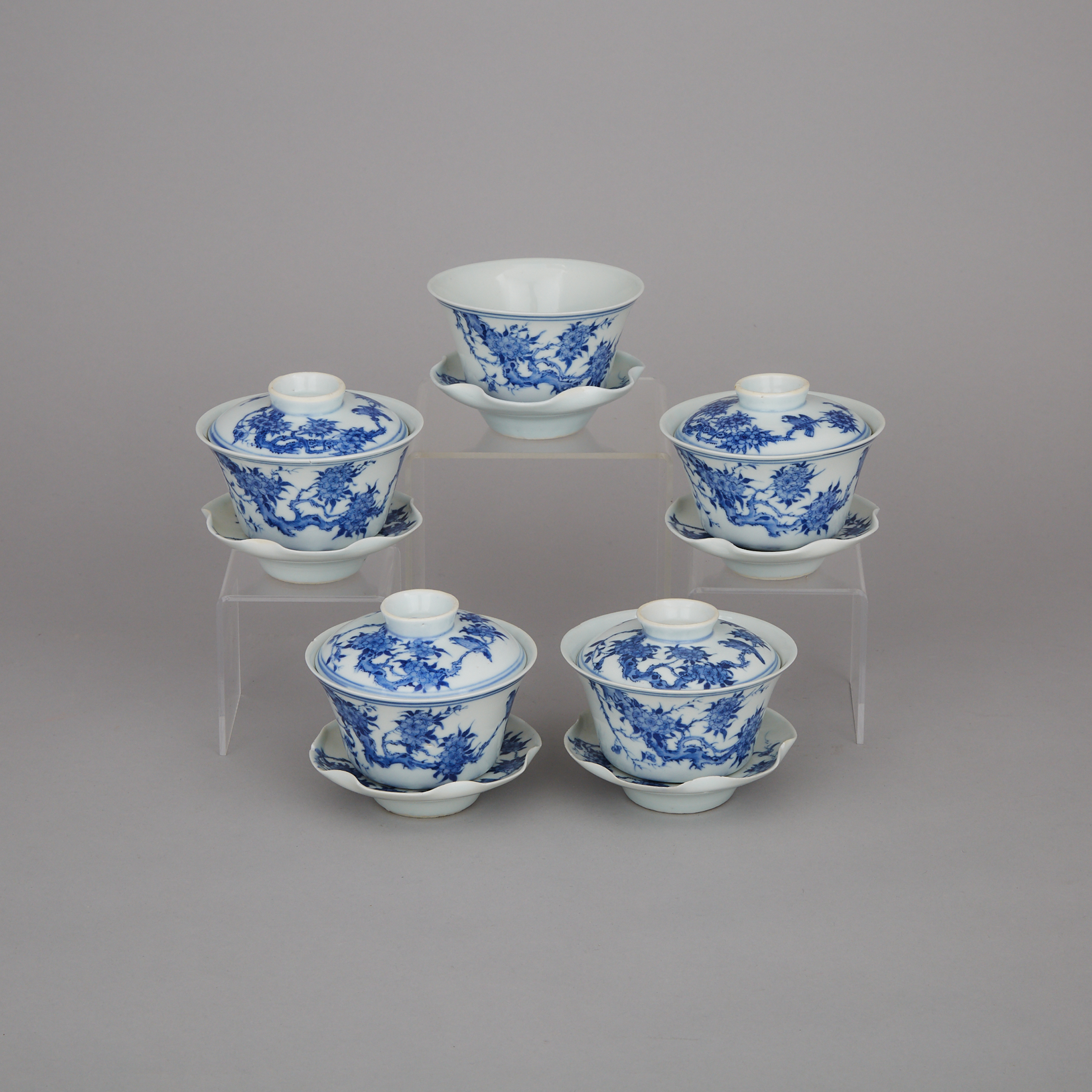 A Set of Five Blue and White Lidded Tea Cups