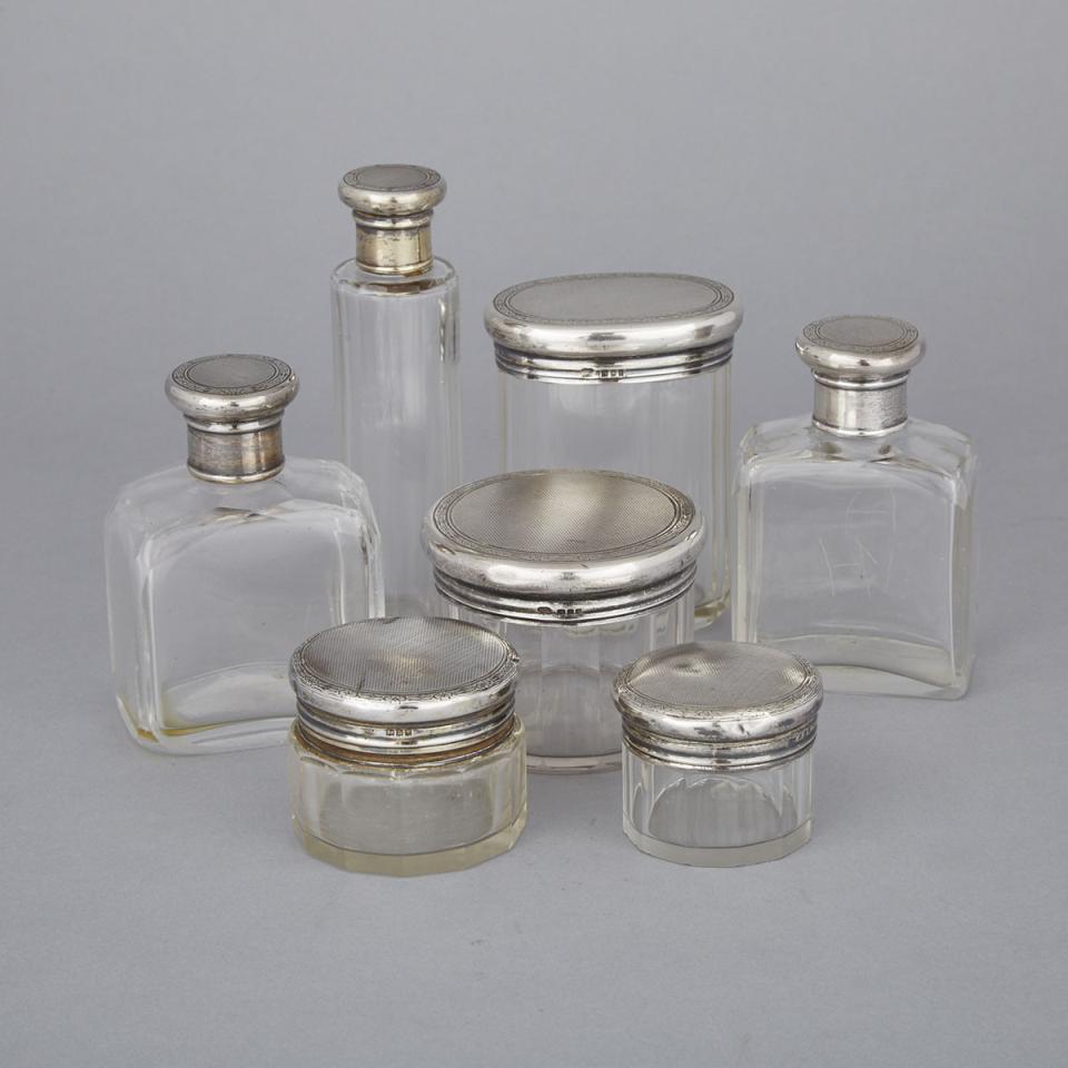 Seven English Silver Mounted Cut Glass Dressing Table Bottles and Jars, c.1917-32