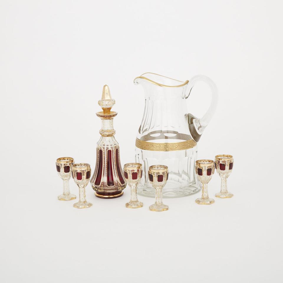 Bohemian Red and Gilt Decorated Cut Glass Decanter and Six Liqueur Glasses, together with a Water Jug, possibly Moser, late 19th/early 20th century