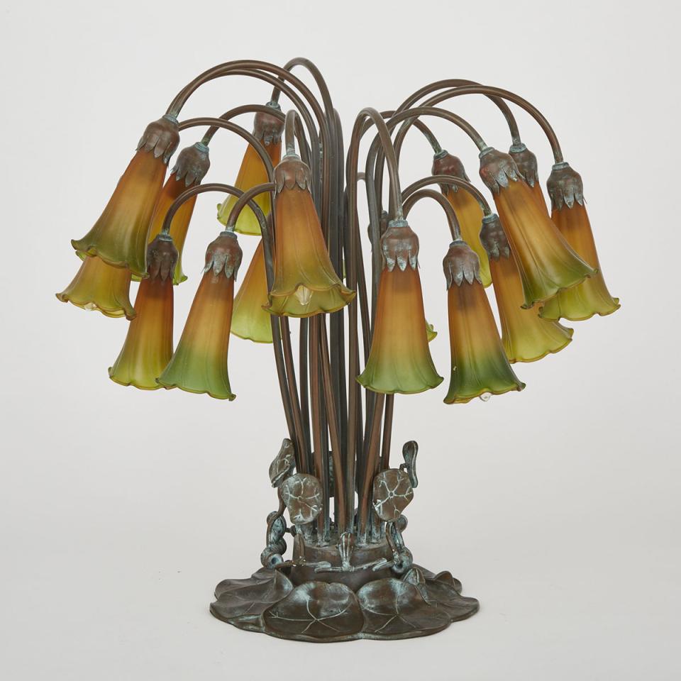 Tiffany Style Patinated Bronze and Favrille Glass Pond Lily 18 Light Table Lamp, 20 century