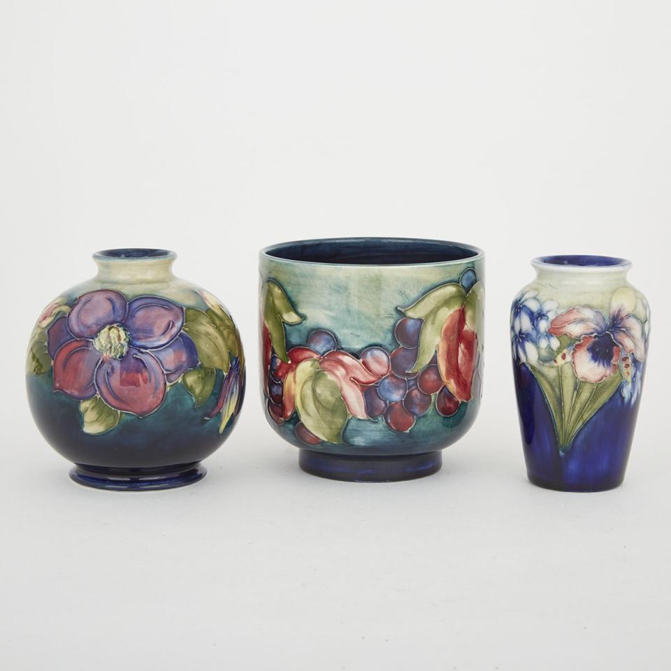 Three Moorcroft Vases: Orchids, Grape and Leaf and Clematis, c.1935-65