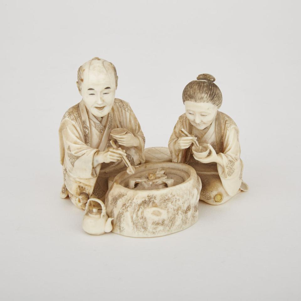 A Japanese Carved Ivory Okimono of A Couple Having Dinner, Early 20th Century 
