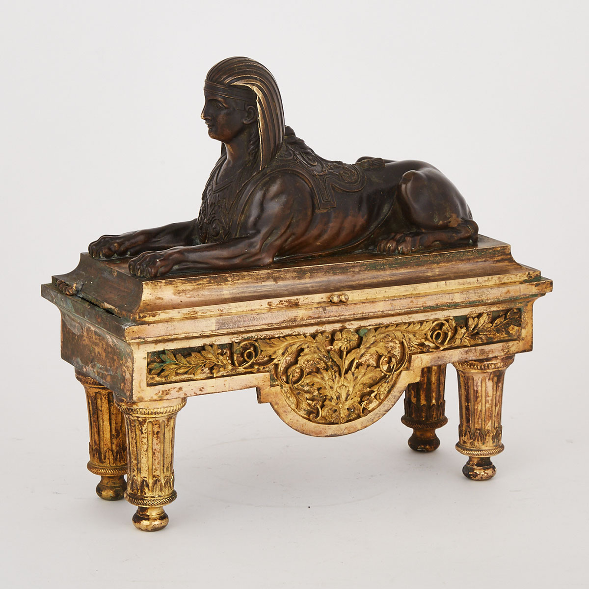 Louis XVI Gilt and Patinated Bronze Sphinx Form Chenet, late 18th century