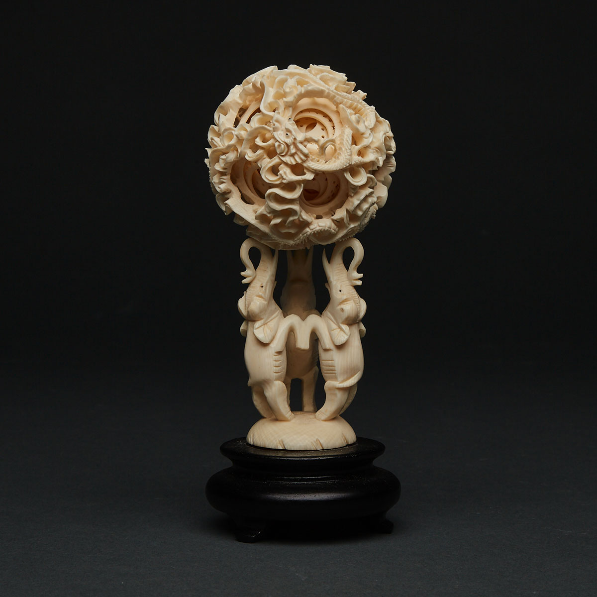 An Ivory Carved Puzzle Ball and Elephant Stand
