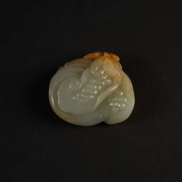 A Chinese White and Russet Jade Ruyi Carving