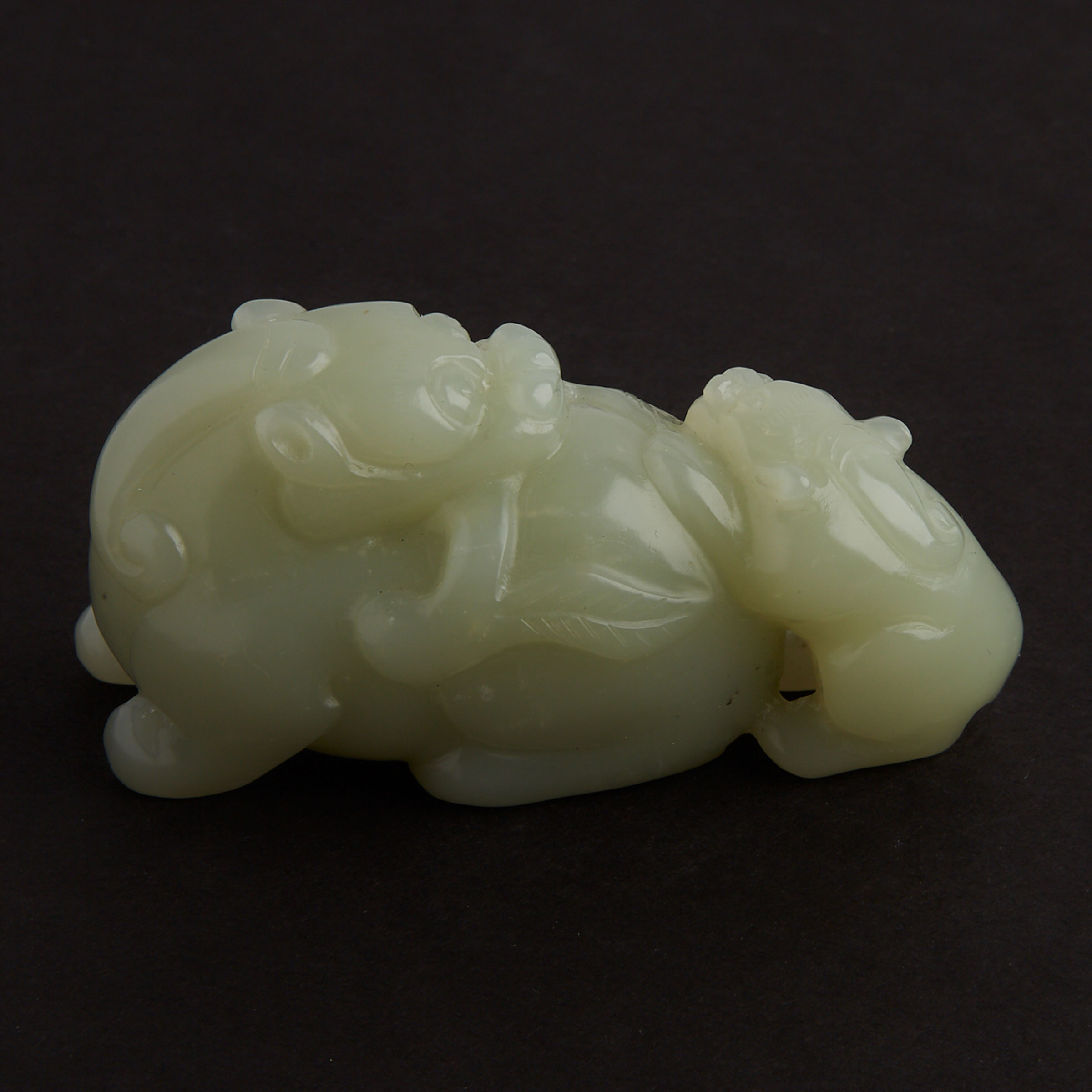 A Celadon White Jade ‘Shishi’ Carving