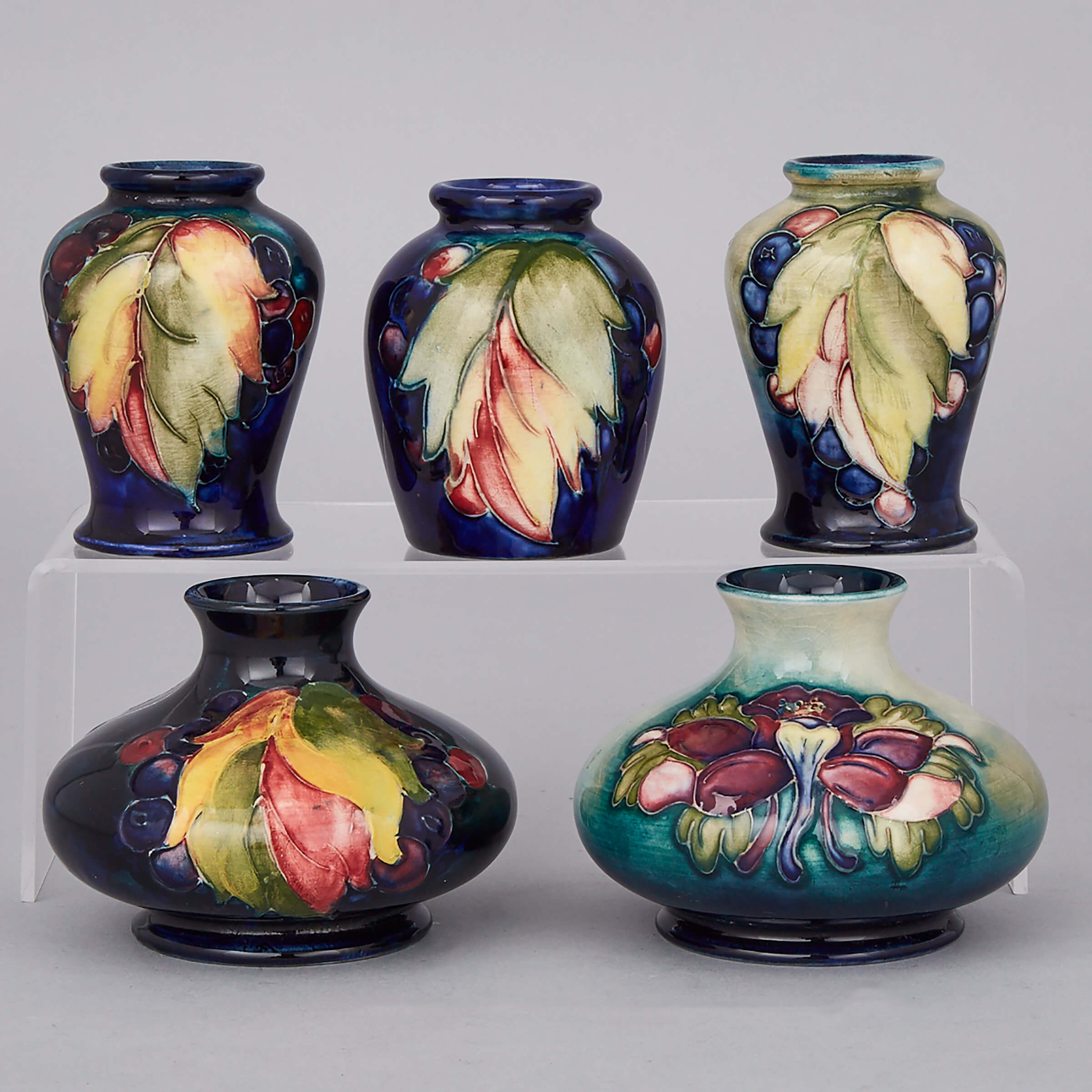 Four Moorcroft Grape and Leaf Small Vases and a Columbine Vase, 1940s