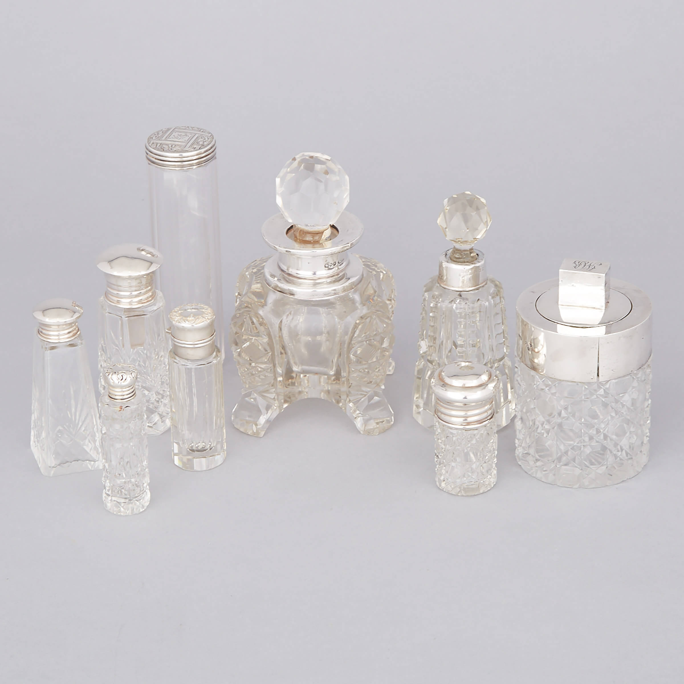 Nine Mainly English Silver Mounted Cut Glass Dressing Table Bottles, 20th century