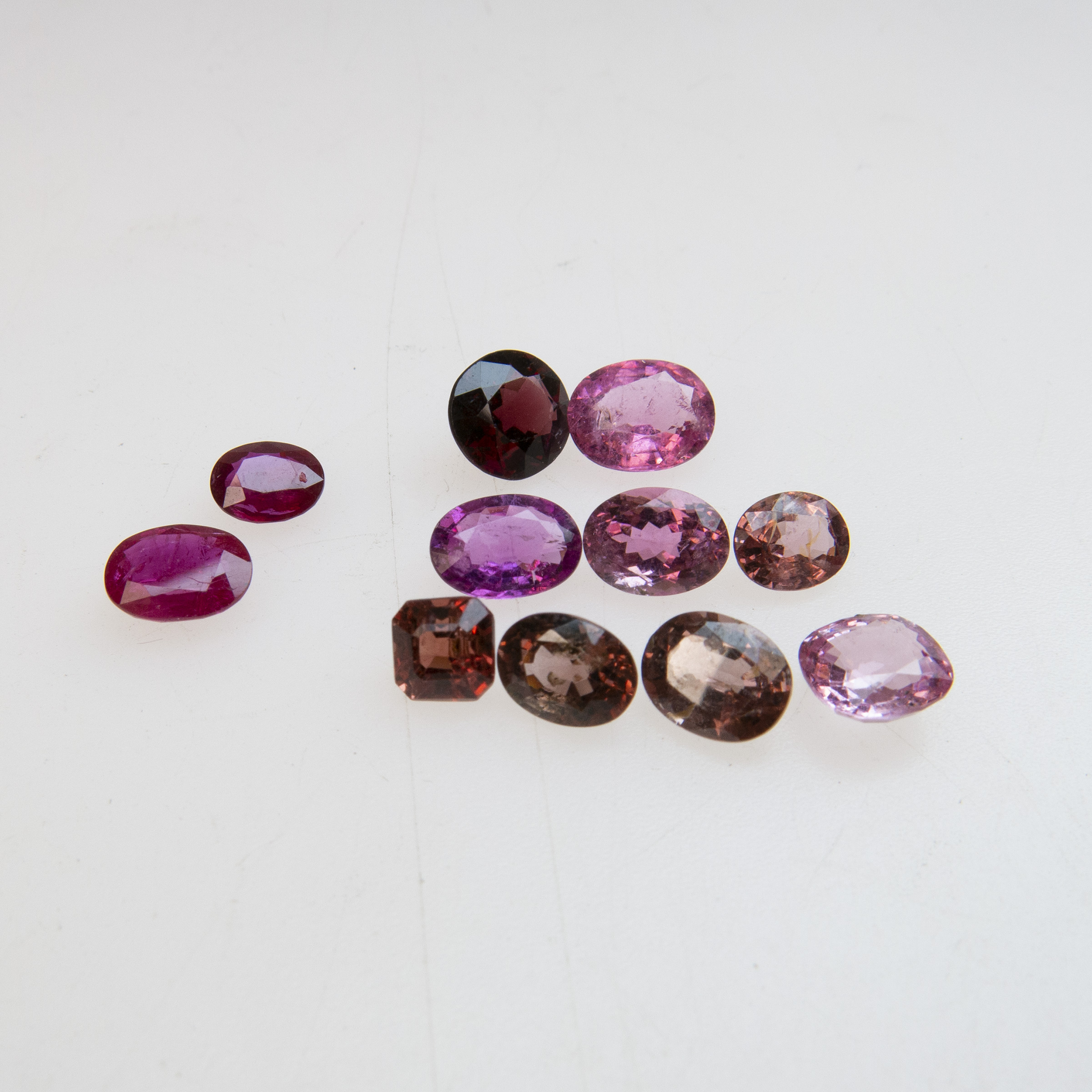 Two Unmounted Oval Cut Rubies And Nine Unmounted Various Cut Spinels